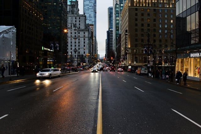 Downtown-Denver-Street-With-Cars-Headlights.jpg