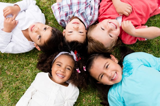 Happy group of kids lying on the floor in a circle .jpeg