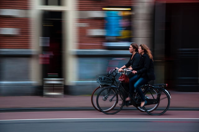 Two-women-bicycling-in-city.jpg