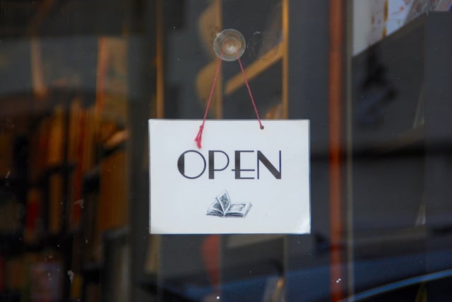 white-open-sign-with-book