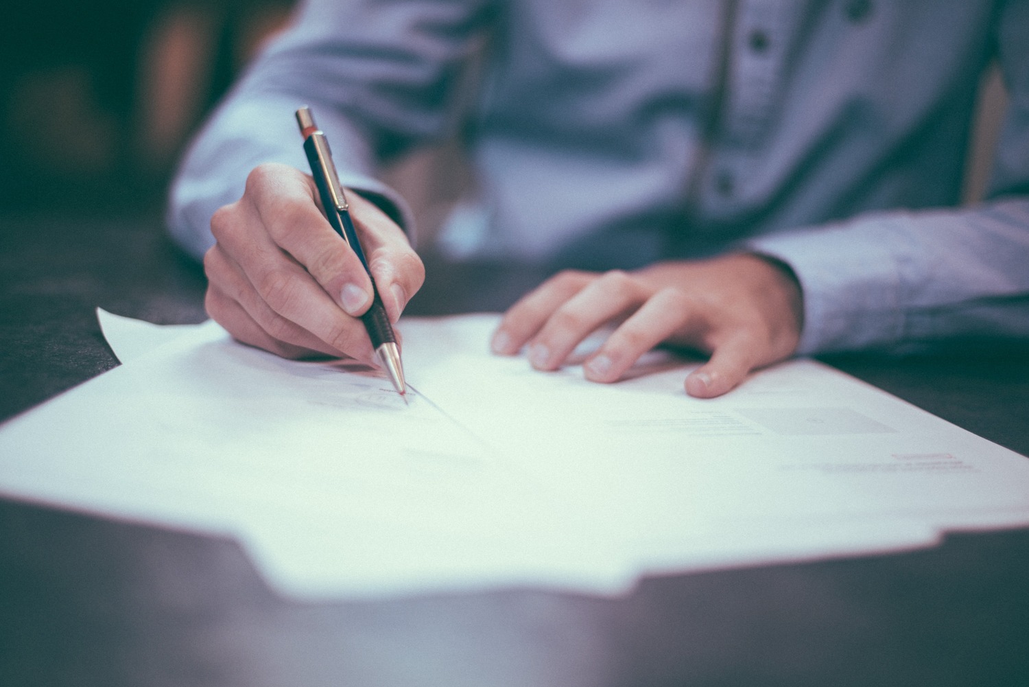 Blue-shirt-signing-paper (1)